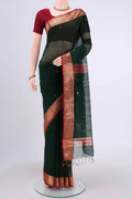 Bottle Green Maheshwari Silk Cotton Saree with Zari Butta on the body and Zari Border.  displayed on a mannequin