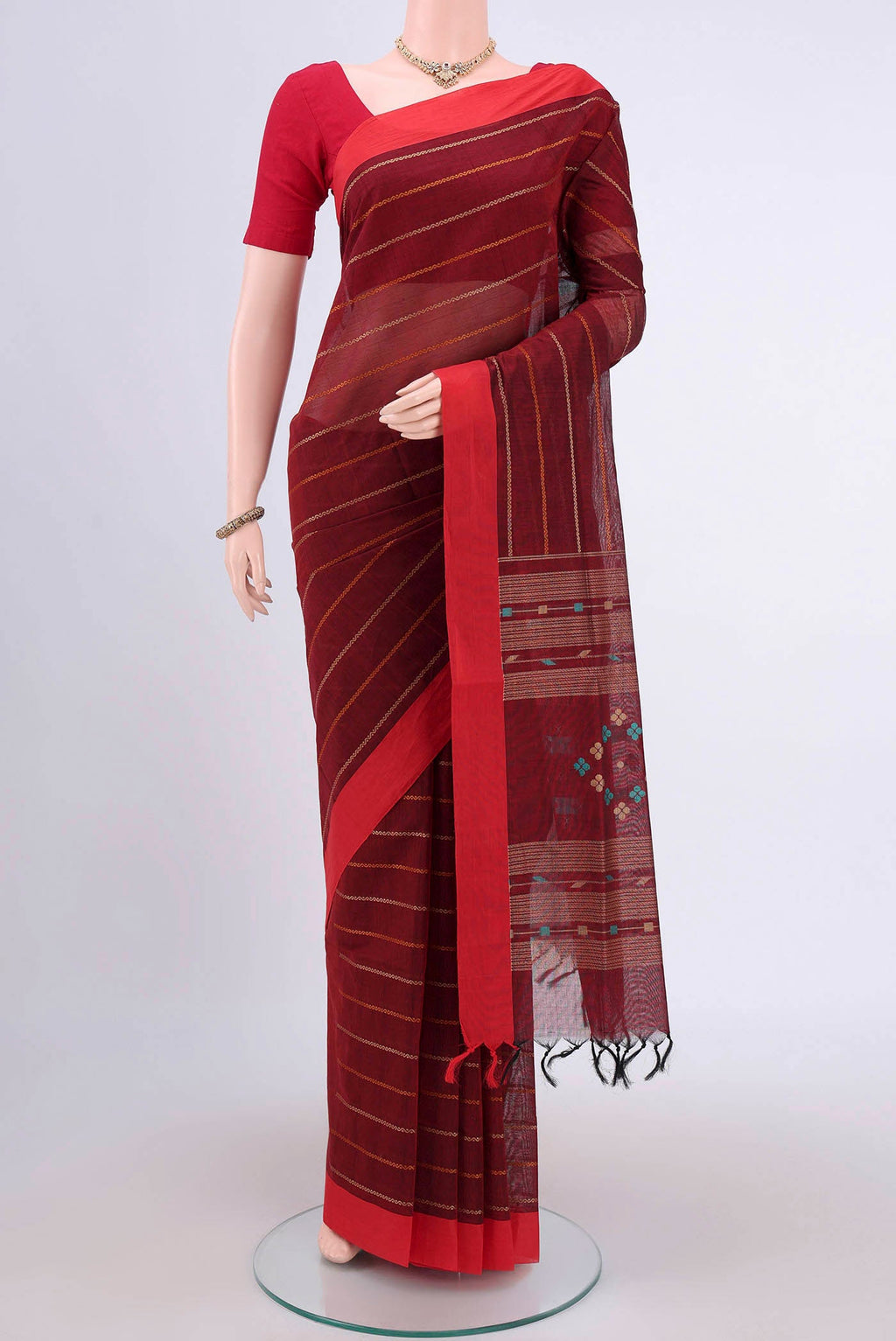 Maroon Coimbatore Cotton Saree with Stripes on the body and Plain Border.  displayed on a mannequin