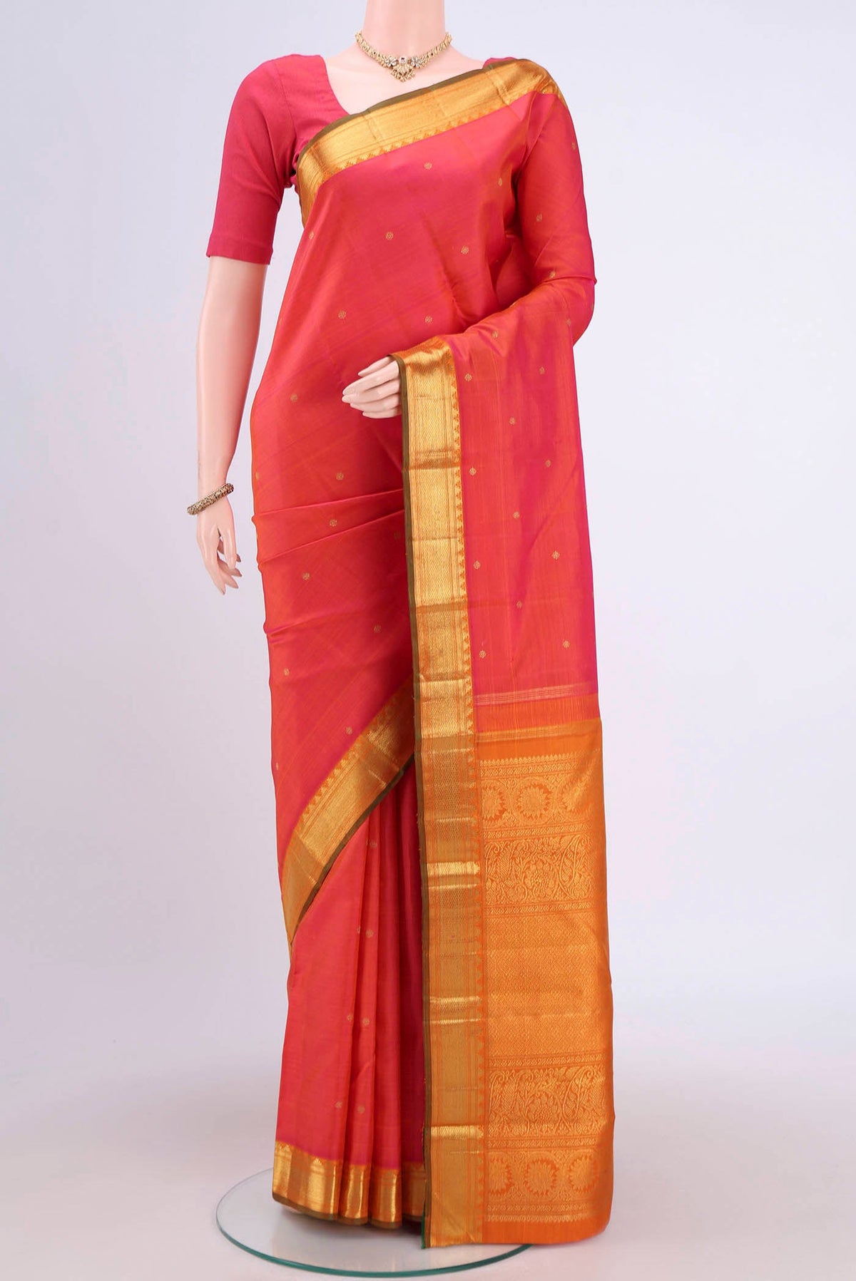 Pure Silk Pure Zari Orange with Pink Dual Tone Kanjivaram Saree with Zari Butta on the body and Zari Border.  displayed on a mannequin