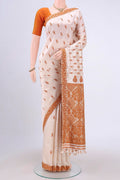 Cream Assam Silk Saree with Thread Butta on the body and Thread Border.  displayed on a mannequin