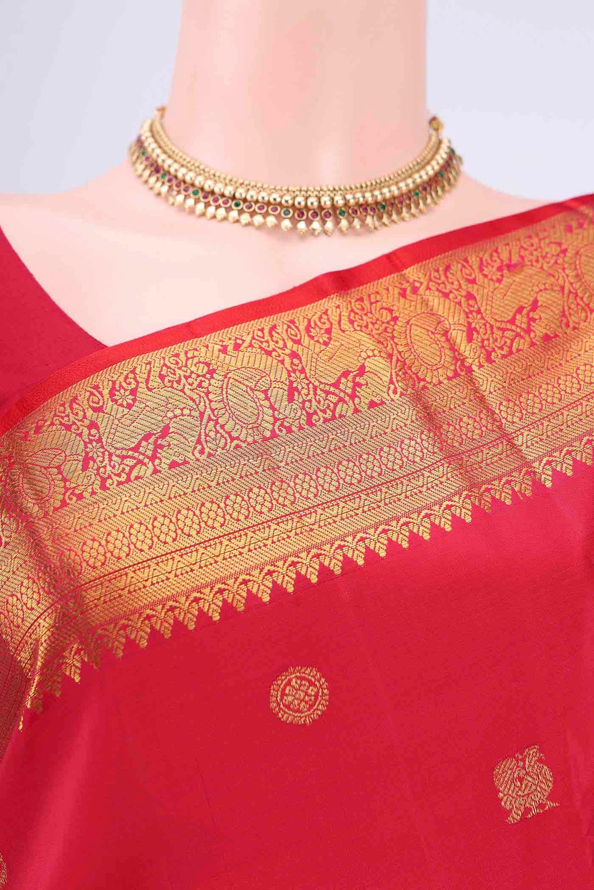 Border image of Red Kanjivaram Saree with Zari Butta on the body and Zari Border. 