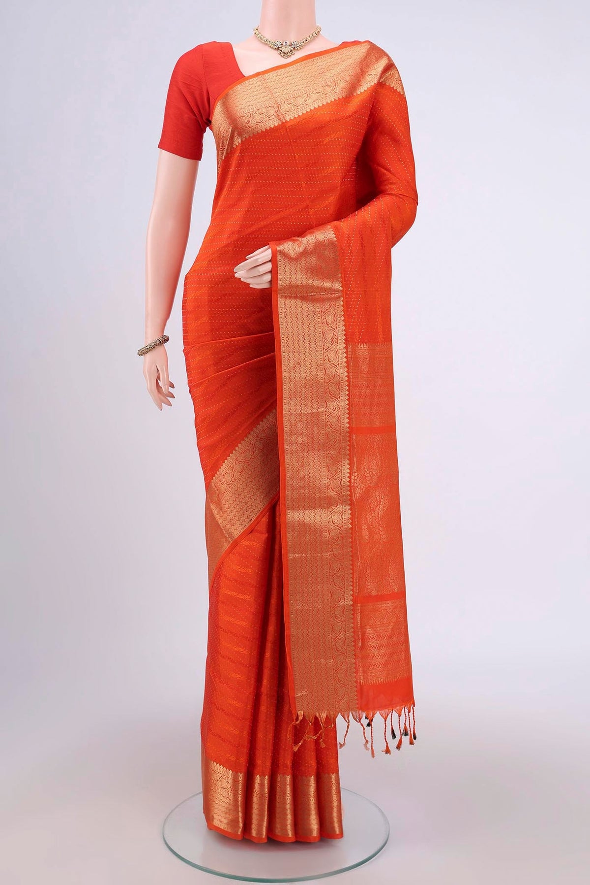 Orange Soft Silk Saree with Jacquard With Zari Butta on the body and Zari Border.  displayed on a mannequin