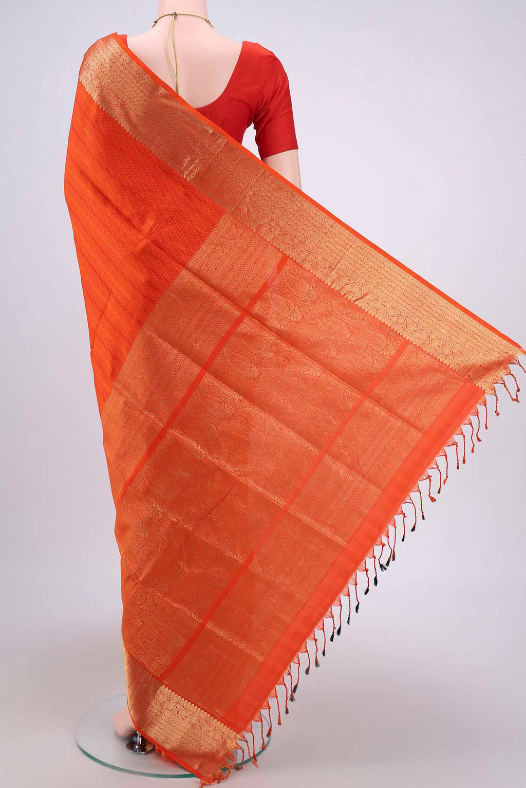 Flat view of Orange Soft Silk Saree with Jacquard With Zari Butta on the body and Zari Border. 