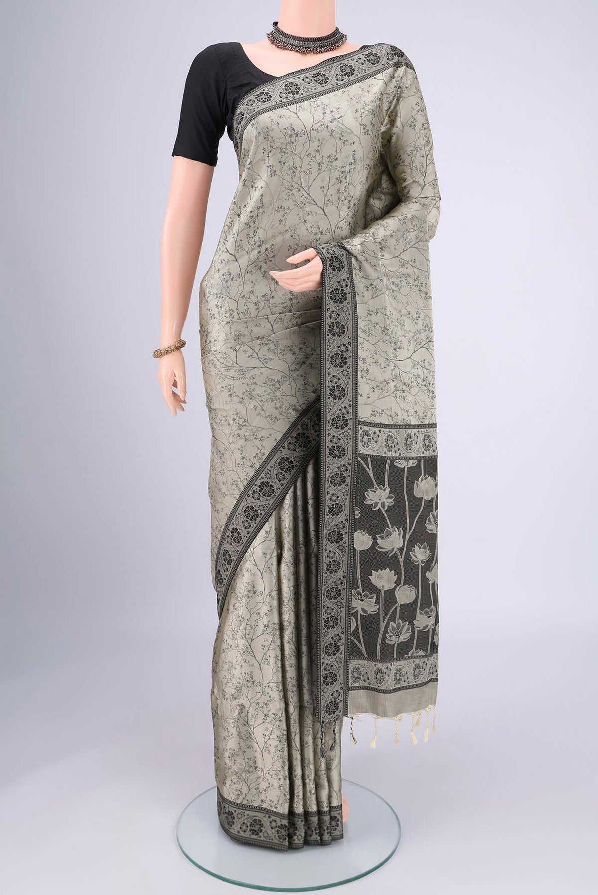 Davys Grey Soft Silk Saree with Jacquard design on the body and Thread Border.  displayed on a mannequin