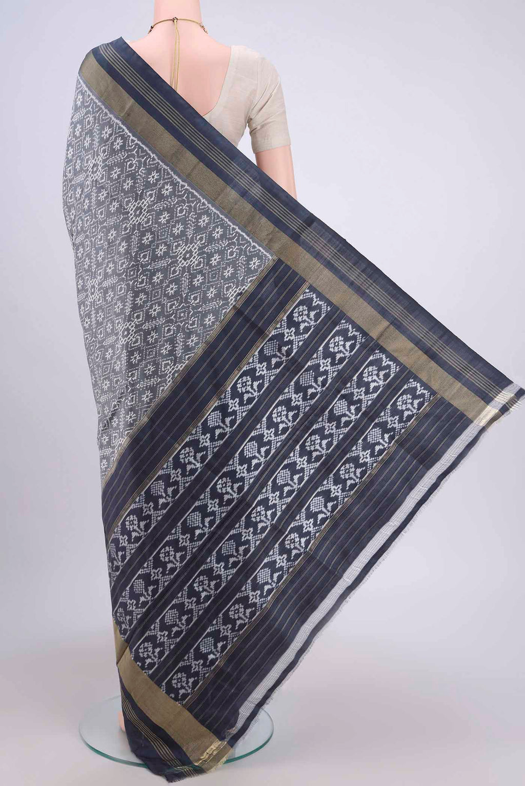 Flat view of Grey Pochampally Silk Saree with Pure Ikat on the body and Zari Border. 