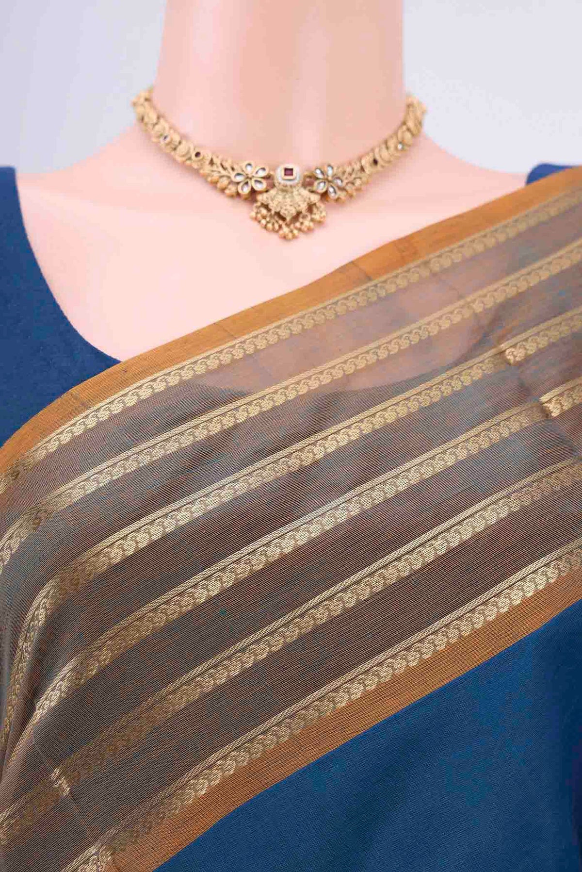 Border image of Blue Silk Cotton Saree with Zari Butta on the body and Zari Border. 