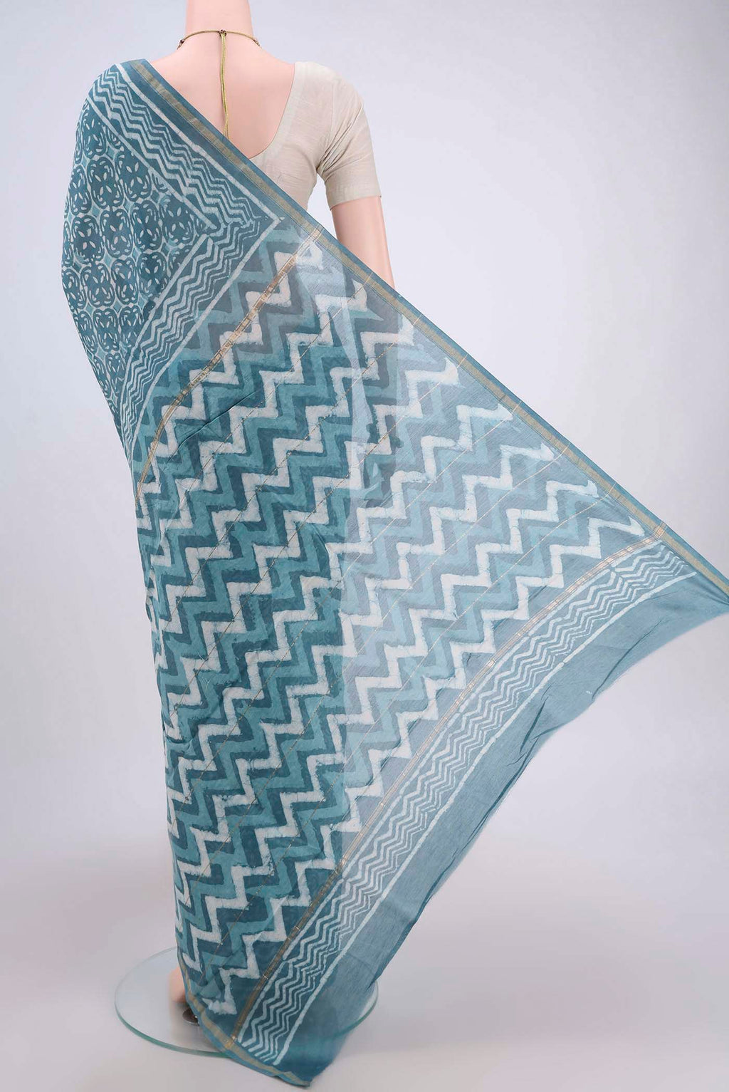 Flat view of Maya Blue Maheshwari Silk Cotton Saree with Printed design on the body and Thin Zari Line. 