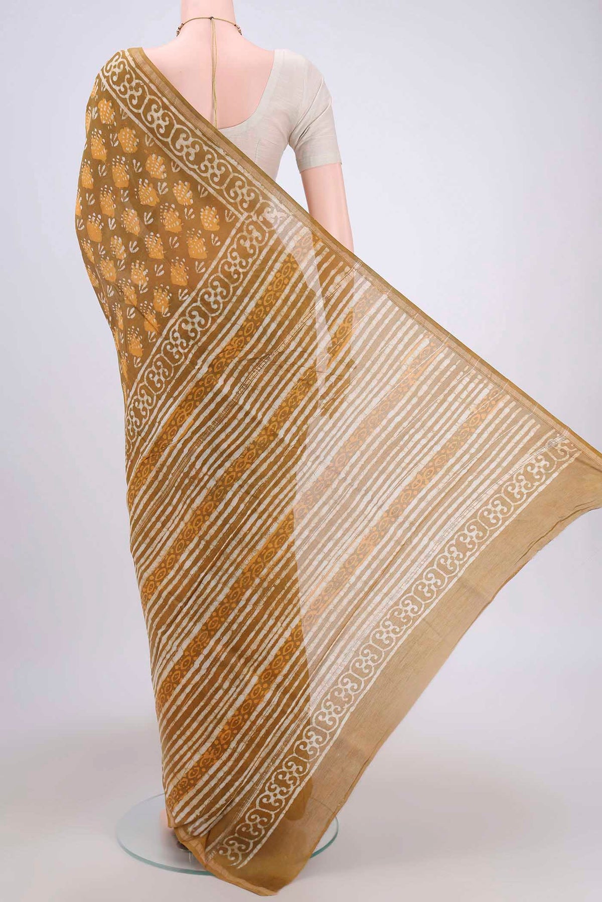 Flat view of Mustard Maheshwari Silk Cotton Saree with Batik Print on the body and Zari Border. 