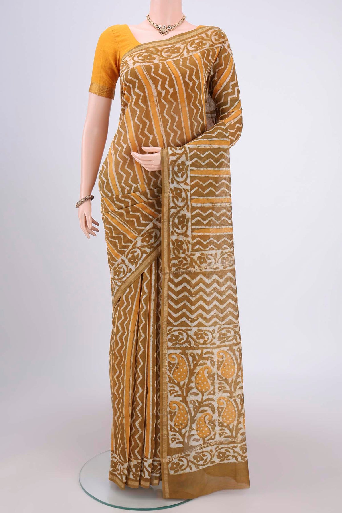 Mehandi Green Chanderi Silk Saree with Batik Print on the body and Zari Border.  displayed on a mannequin
