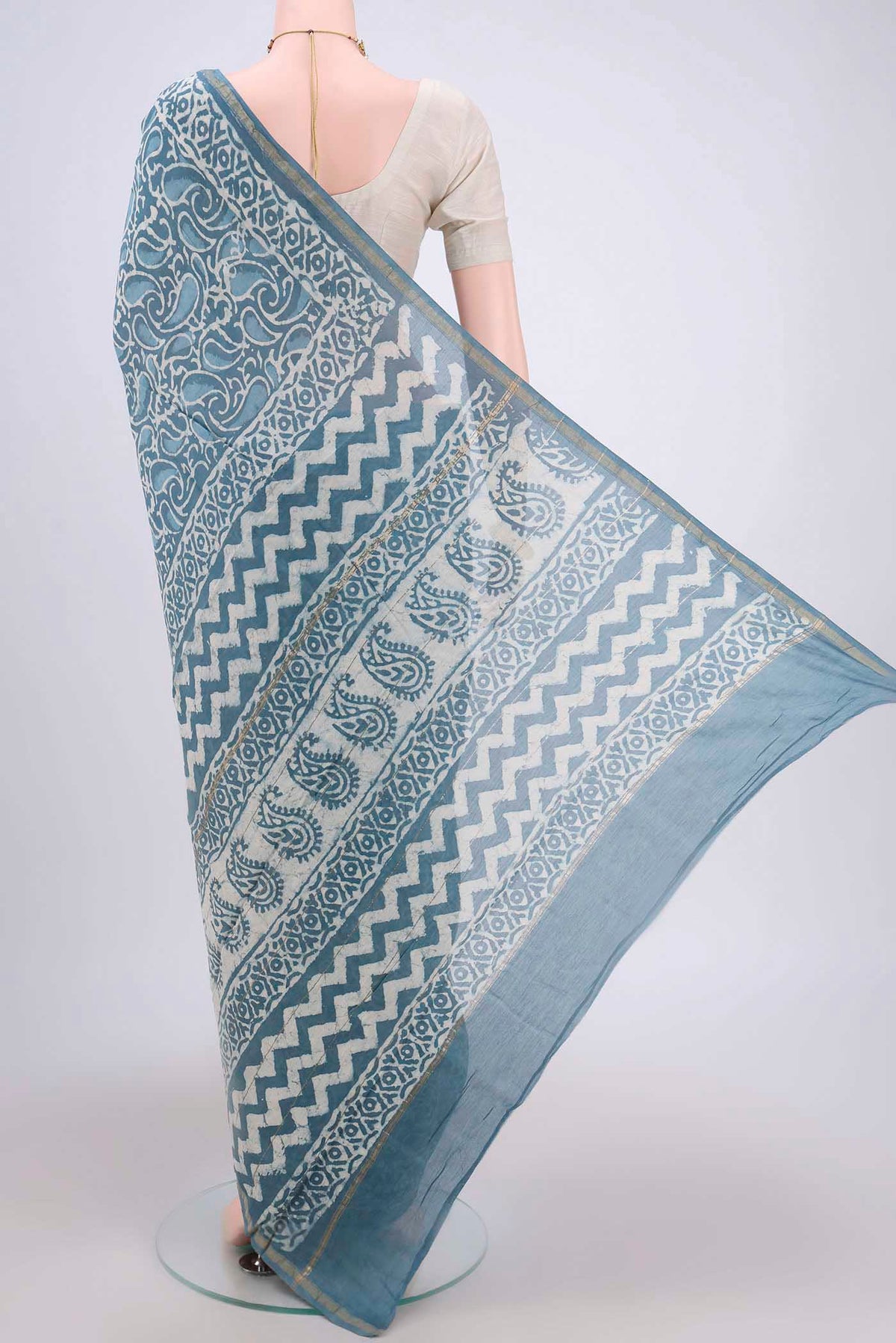 Flat view of Blue Maheshwari Silk Cotton Saree with Batik Print on the body and Zari Border. 