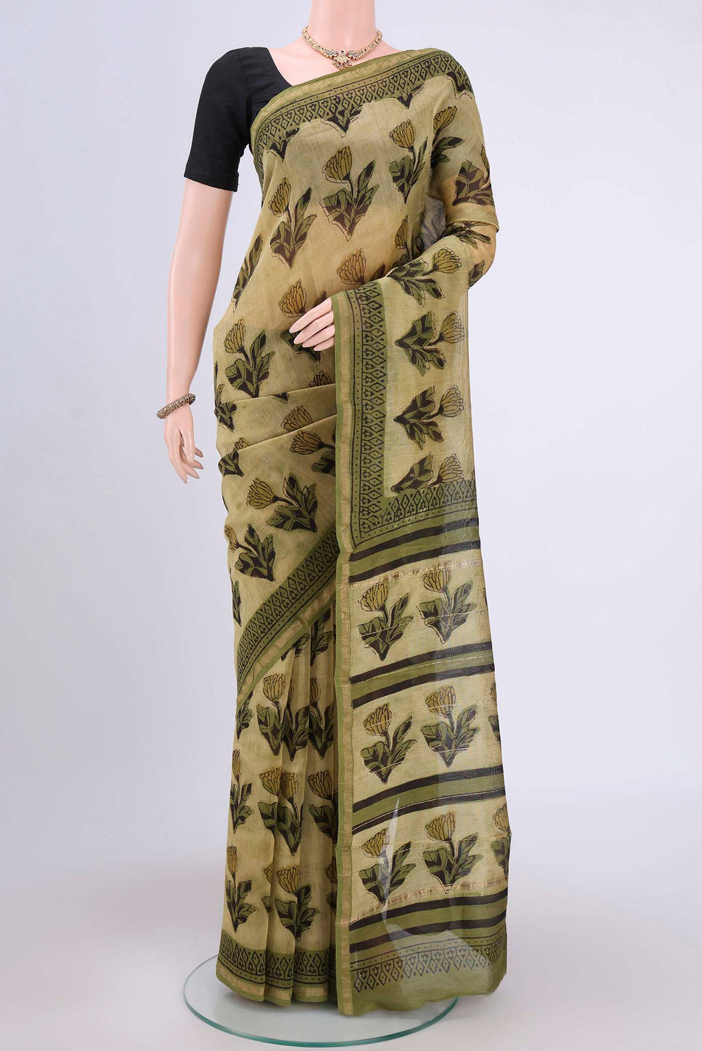 Light Green Chanderi Silk Saree with Printed design on the body and Zari Border.  displayed on a mannequin