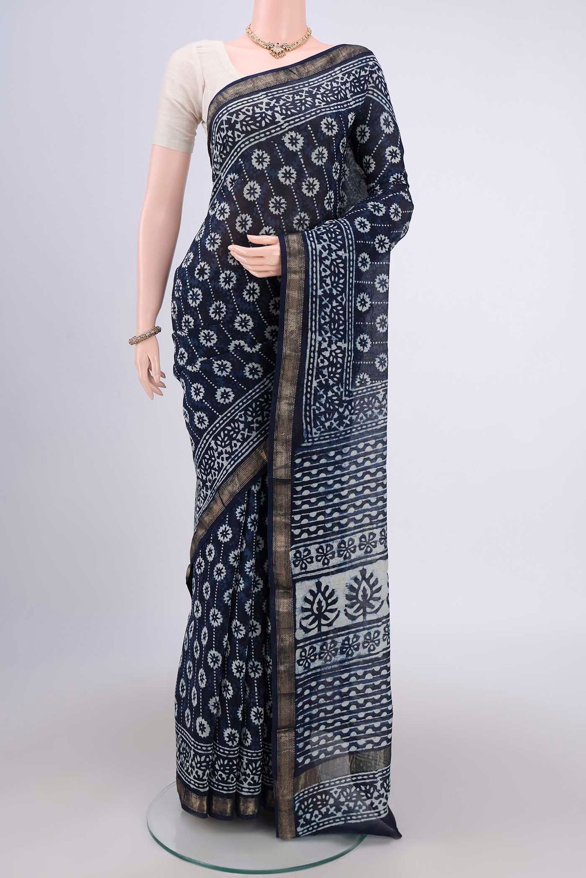 Indigo Maheshwari Silk Cotton Saree with Batik Print on the body and Zari Border.  displayed on a mannequin