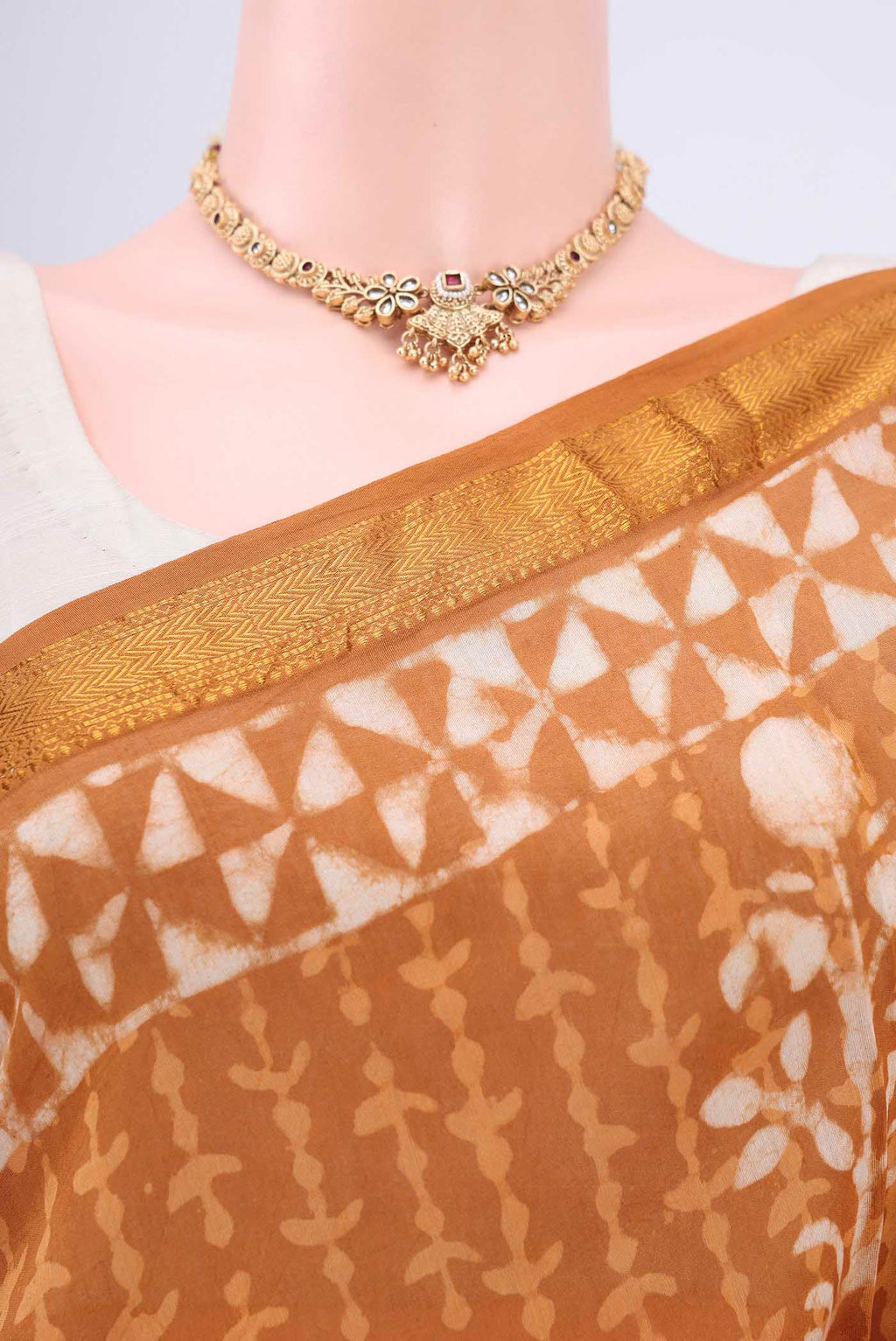 Border image of Rust Maheshwari Silk Cotton Saree with Printed design on the body and Zari Border. 