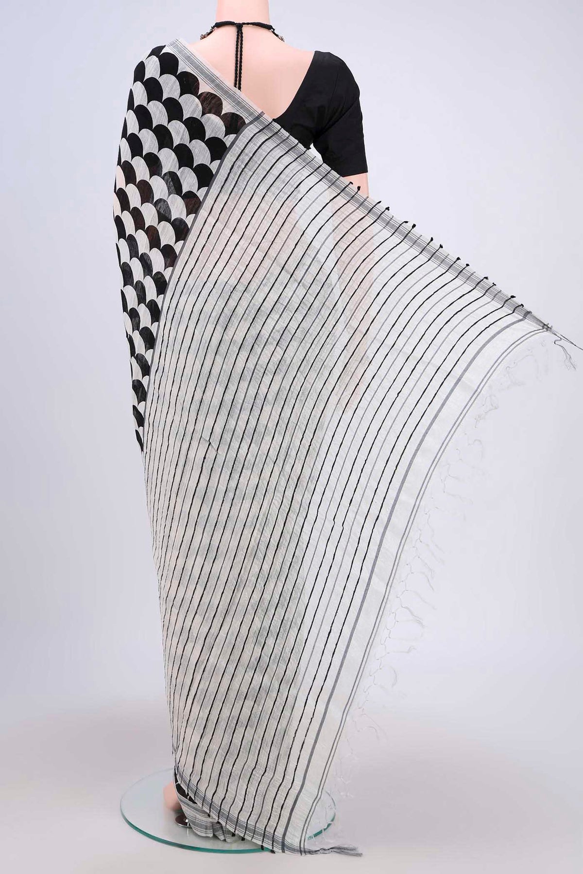 Flat view of Black Tussar Silk Saree with Printed design on the body and Plain Border. 
