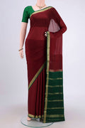 Maroon Mysore Crepe Saree with Plain Body and Zari Border.  displayed on a mannequin