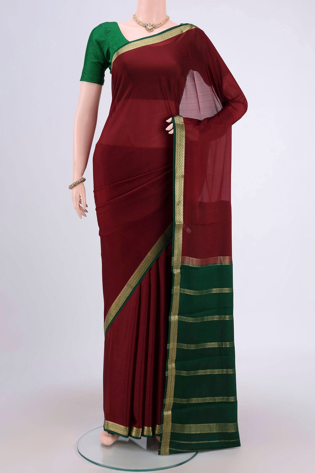 Maroon Mysore Crepe Saree with Plain Body and Zari Border.  displayed on a mannequin