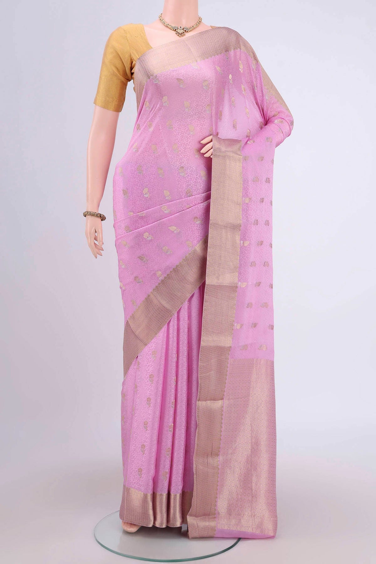Rose pink Mysore Crepe Saree with Zari Butta on the body and Zari Border.  displayed on a mannequin