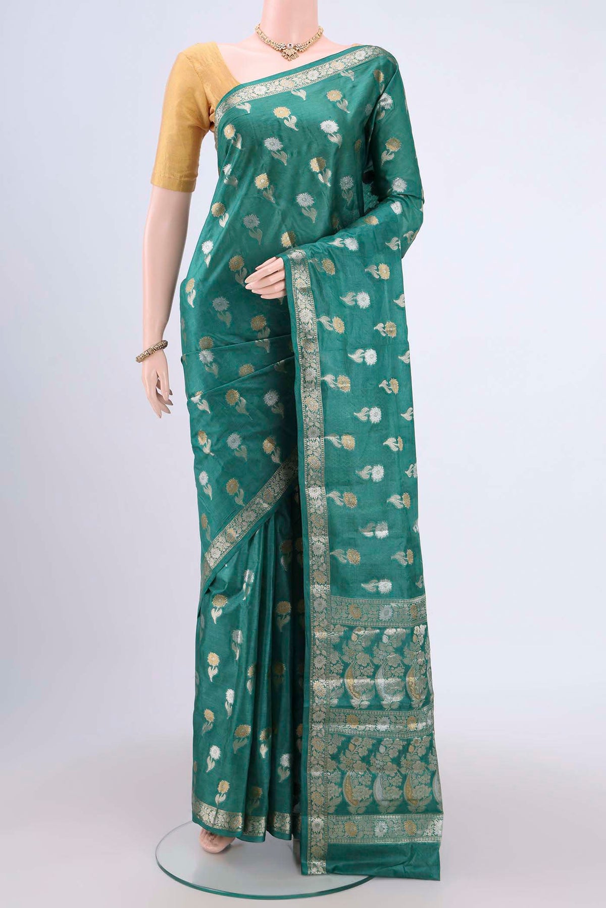Sea Green Banarasi Tussar Silk Saree with Zari Butta on the body and Zari Border.  displayed on a mannequin