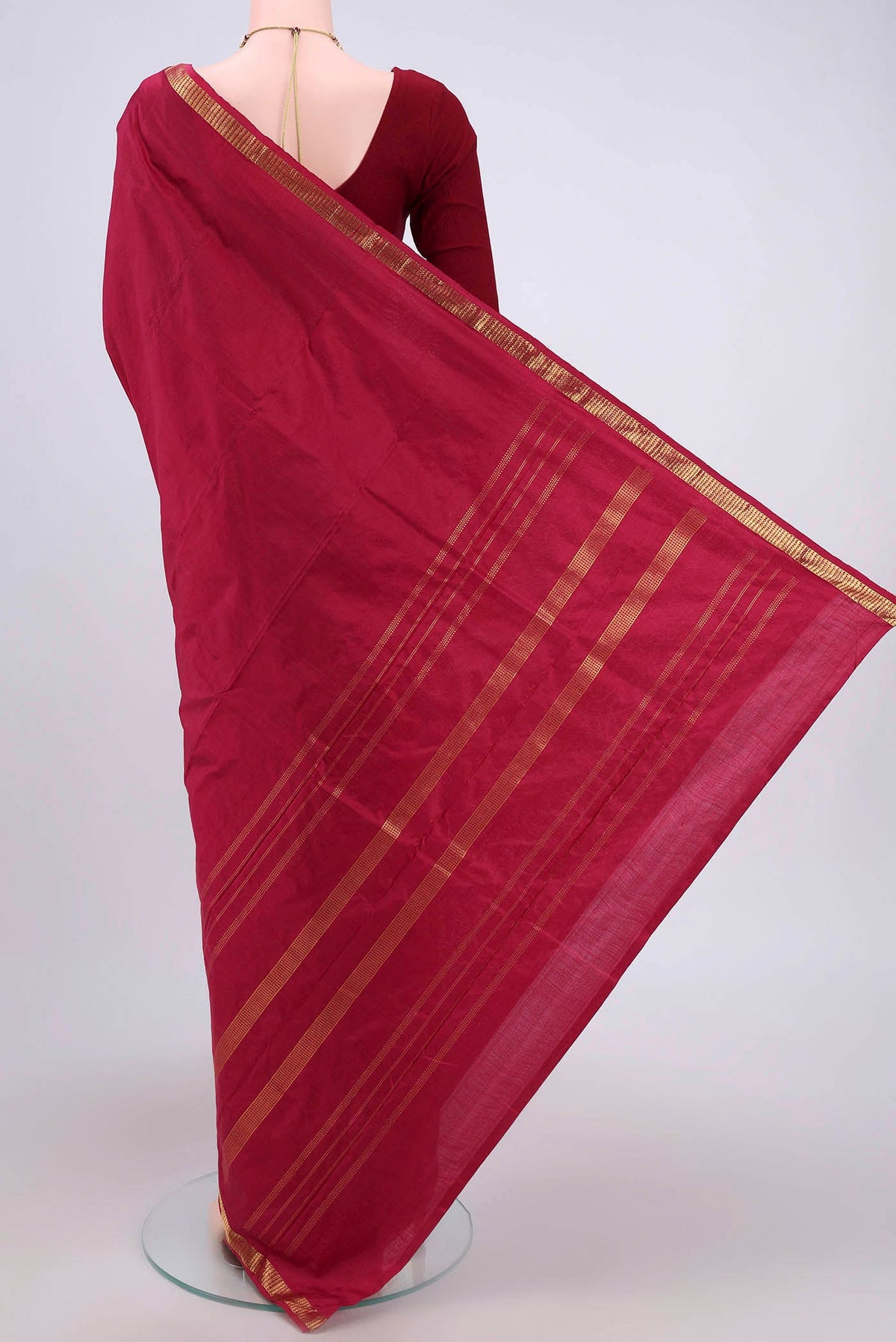 Flat view of Maroon Kanchipuram Silk Saree with Plain Body and Zari Border. 