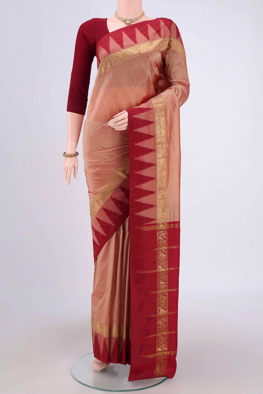 Coral Blended Bangalore Silk Saree with Zari Butta on the body and Temple Border.  displayed on a mannequin