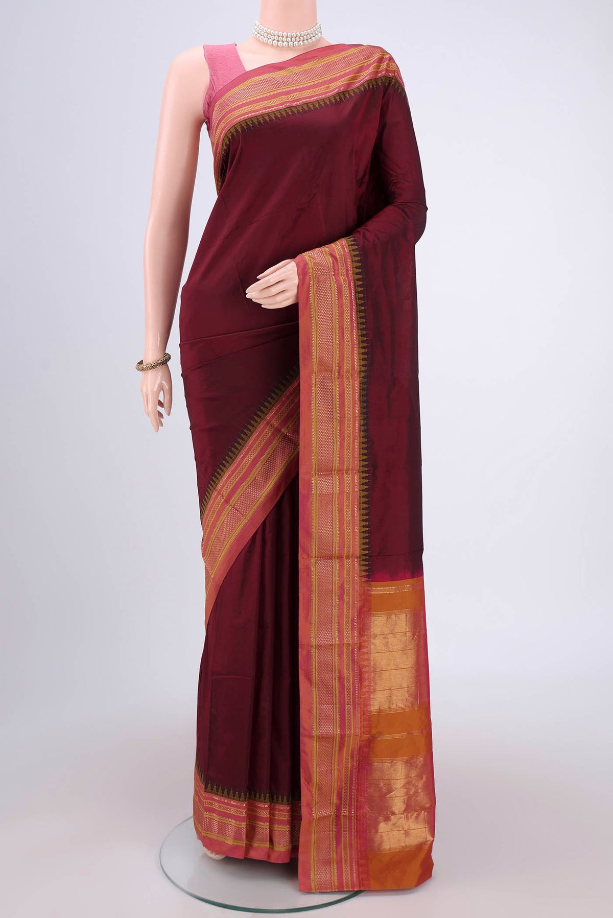 Maroon Blended Bangalore Silk Saree with Plain Body and Temple Border.  displayed on a mannequin