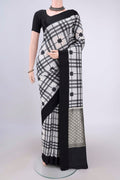 White Soft Silk Saree with Checked design on the body and Without Border.  displayed on a mannequin