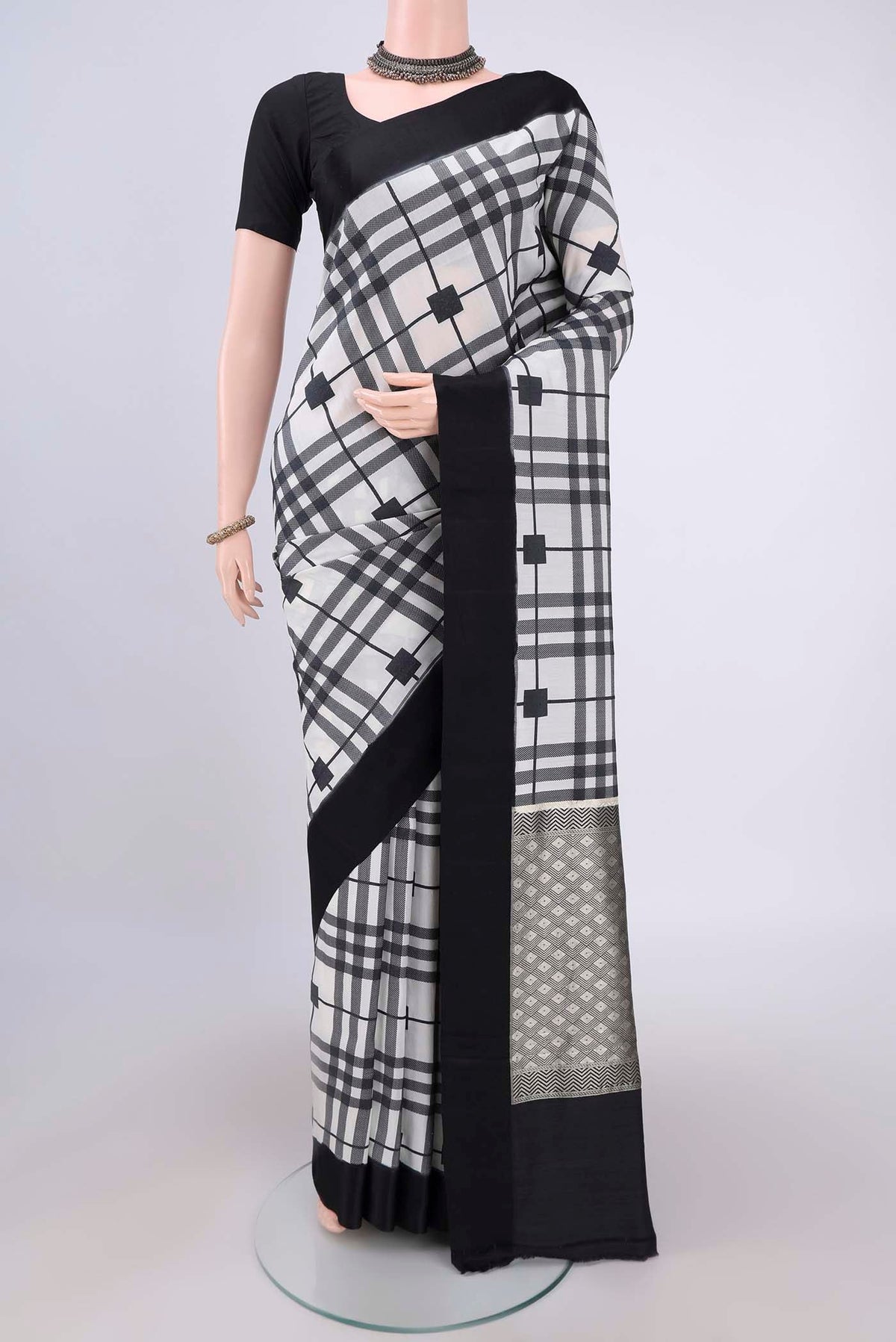 White Soft Silk Saree with Checked design on the body and Without Border.  displayed on a mannequin
