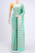 Mint Green Banarasi Raw Silk Saree with Zari Butta on the body and Zari Border.  displayed on a mannequin