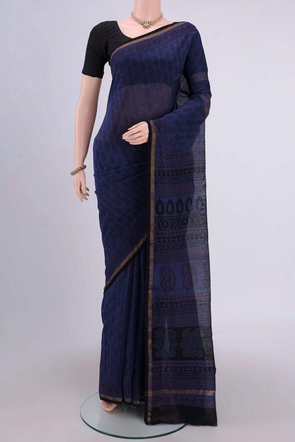 Blue Maheshwari Silk Cotton Saree with Printed design on the body and Zari Border.  displayed on a mannequin