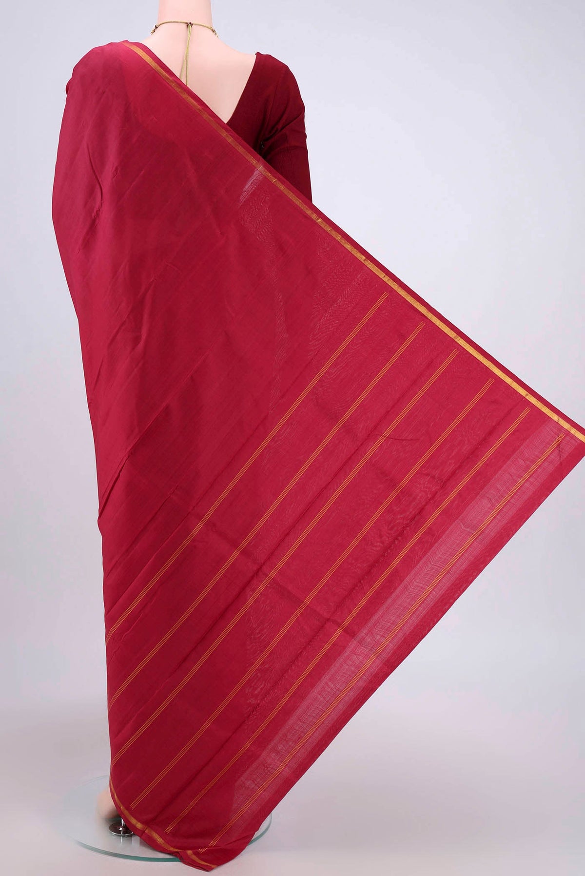 Flat view of Maroon Kanchipuram Silk Saree with Plain Body and Zari Border. 