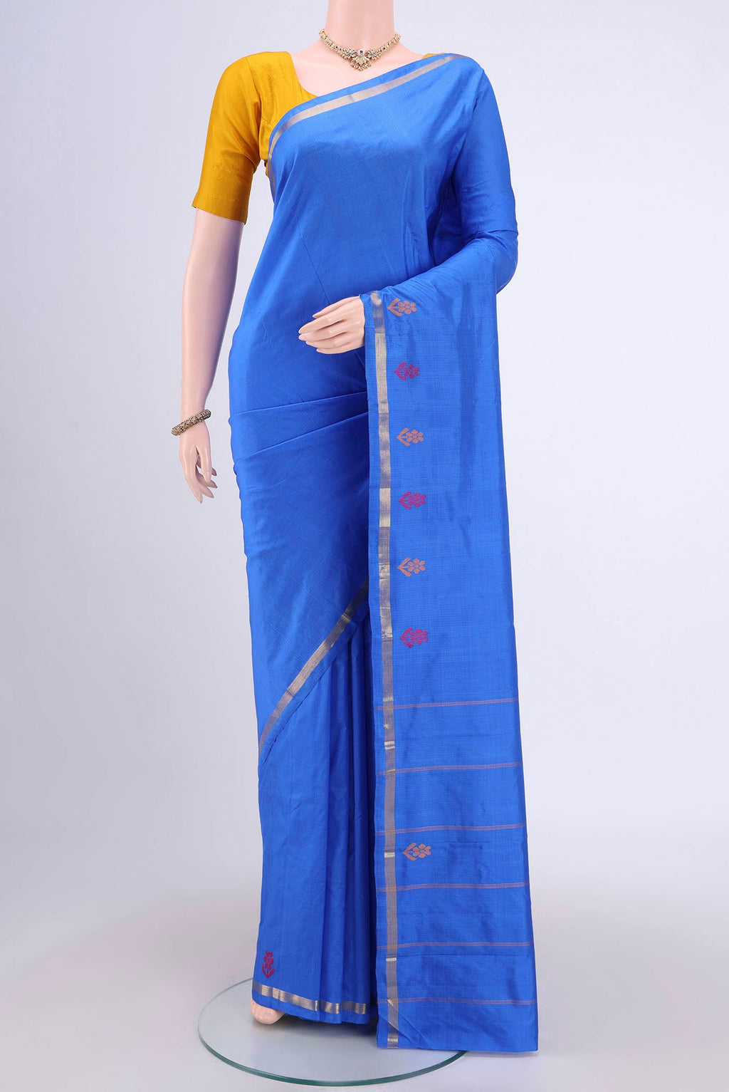 Blue Kanchipuram Saree with Plain Body and Zari And Thread Border.  displayed on a mannequin