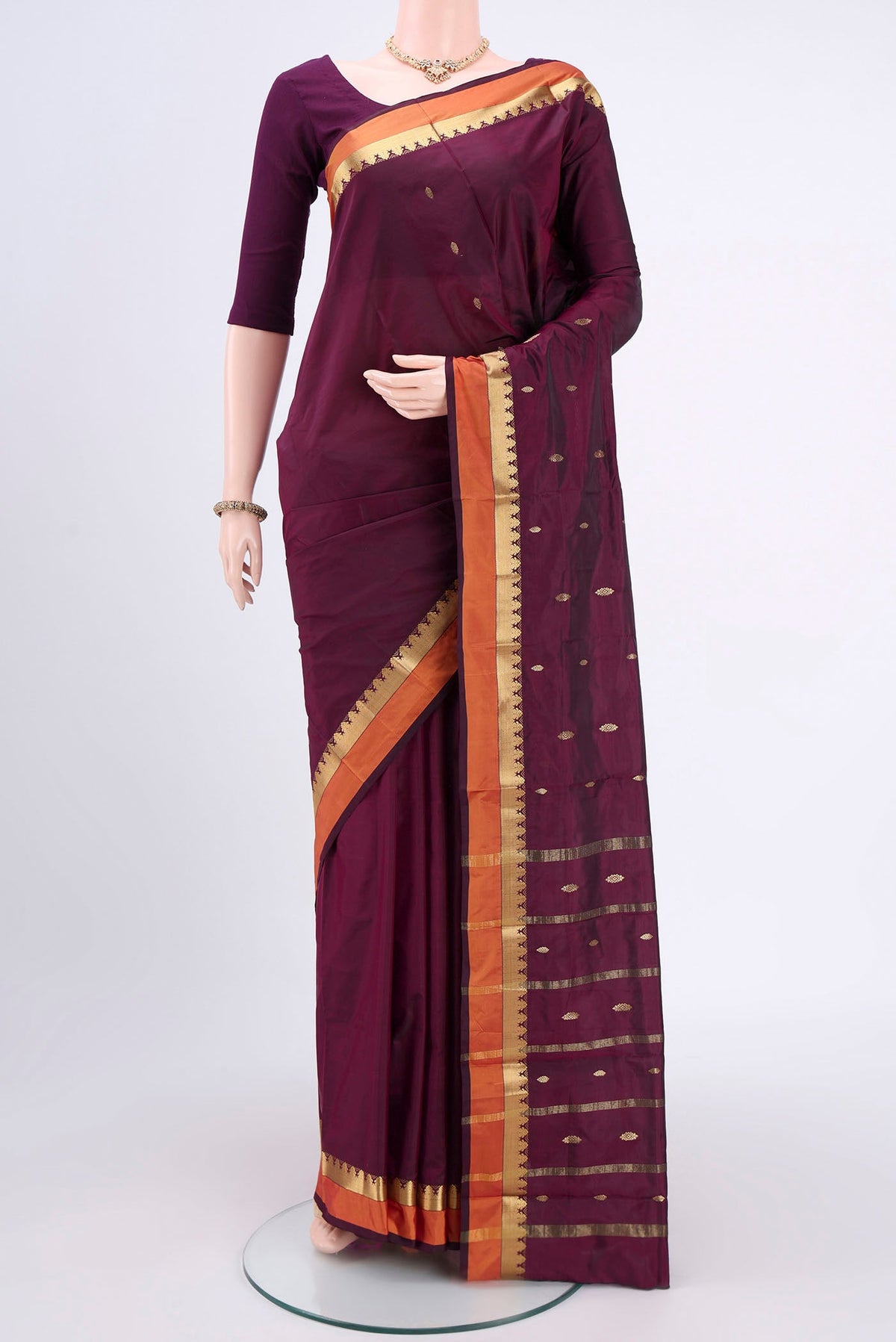 Magenta Blended Bangalore Silk Saree with Zari Butta on the body and Zari Border.  displayed on a mannequin
