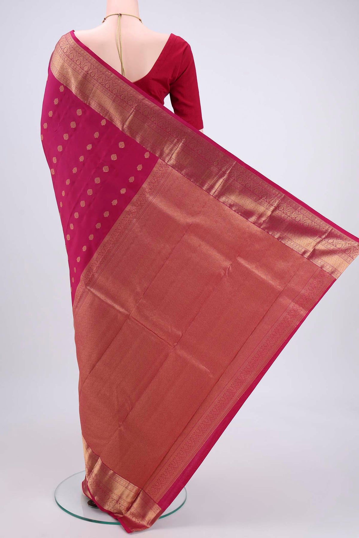 Flat view of Pink Kanchipuram Silk Saree with Zari Butta on the body and Zari Border. 
