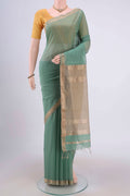 Sage Green Maheshwari Silk Cotton Saree with Stripes on the body and Zari Border.  displayed on a mannequin