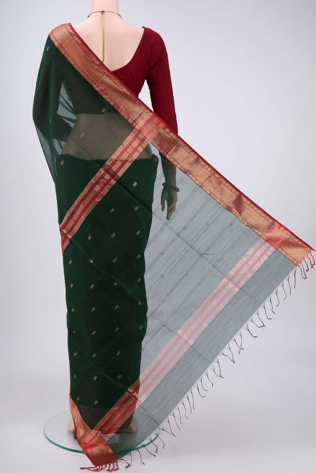 Flat view of Bottle Green Maheshwari Silk Cotton Saree with Plain Body and Zari Border. 