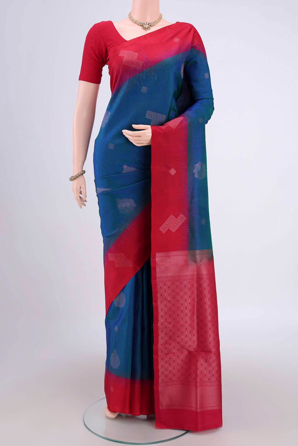 Turquoise Soft Silk Saree with Zari Butta on the body and Zari Border.  displayed on a mannequin