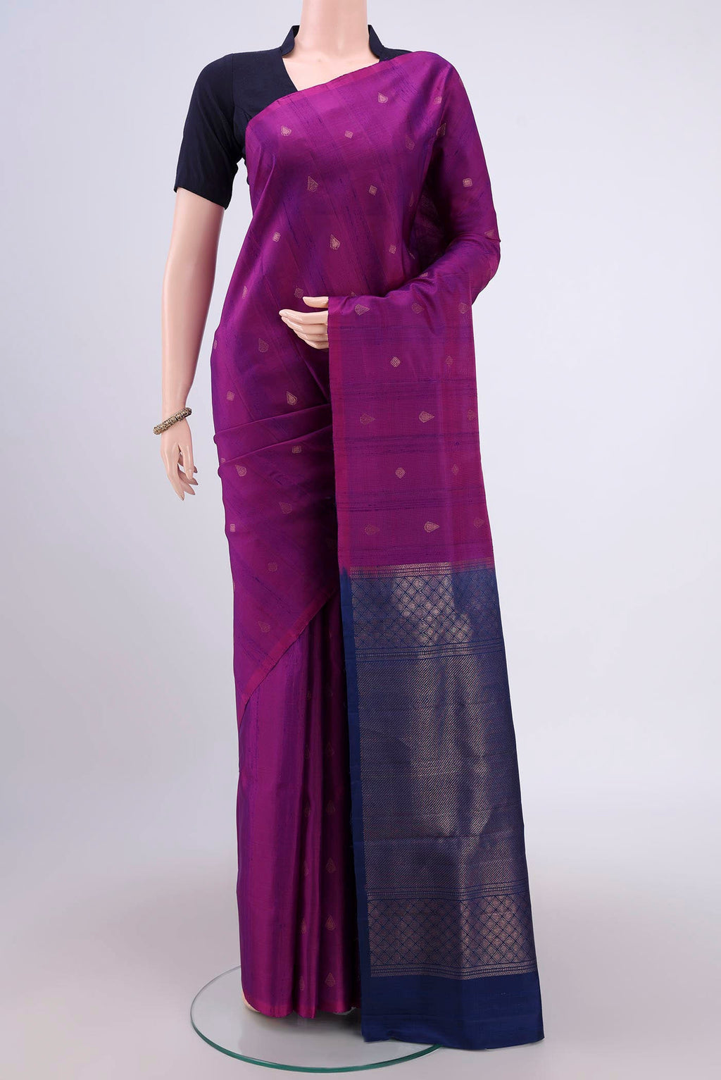 Magenta Soft Silk Saree with Zari Butta on the body and Zari Border.  displayed on a mannequin