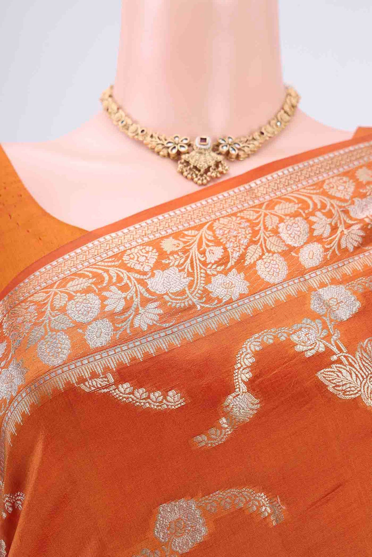 Border image of Rust Banarasi Raw Silk Saree with Zari Butta on the body and Zari Border. 