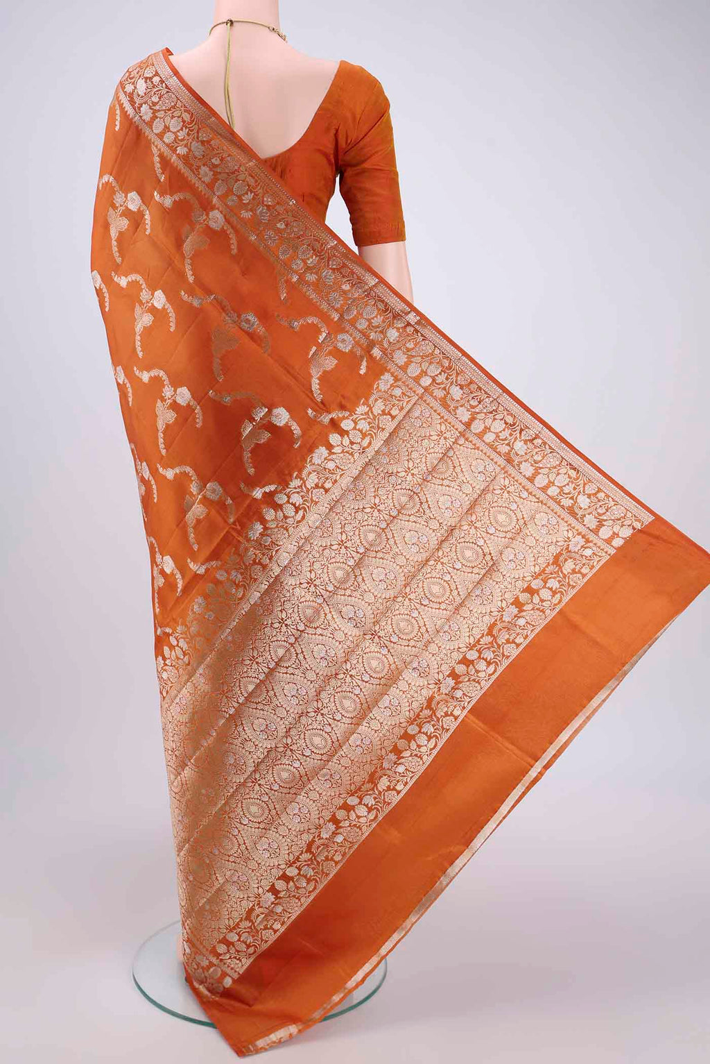 Flat view of Rust Banarasi Raw Silk Saree with Zari Butta on the body and Zari Border. 