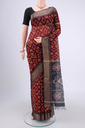 Maroon Silk Cotton Saree with Ikat design on the body and Zari Border.  displayed on a mannequin