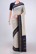 Off White Pochampally Silk Saree with Ikat design on the body and Ikat Border.  displayed on a mannequin