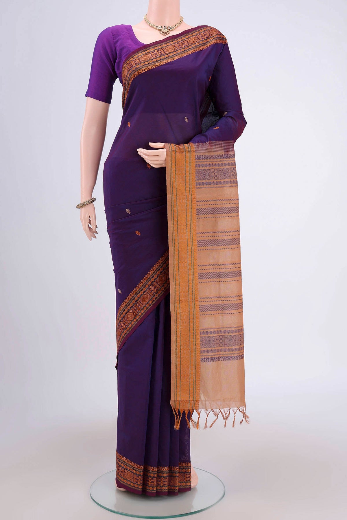 Purple Blended Poly Cotton Saree with Thread Butta on the body and Thread Border.  displayed on a mannequin