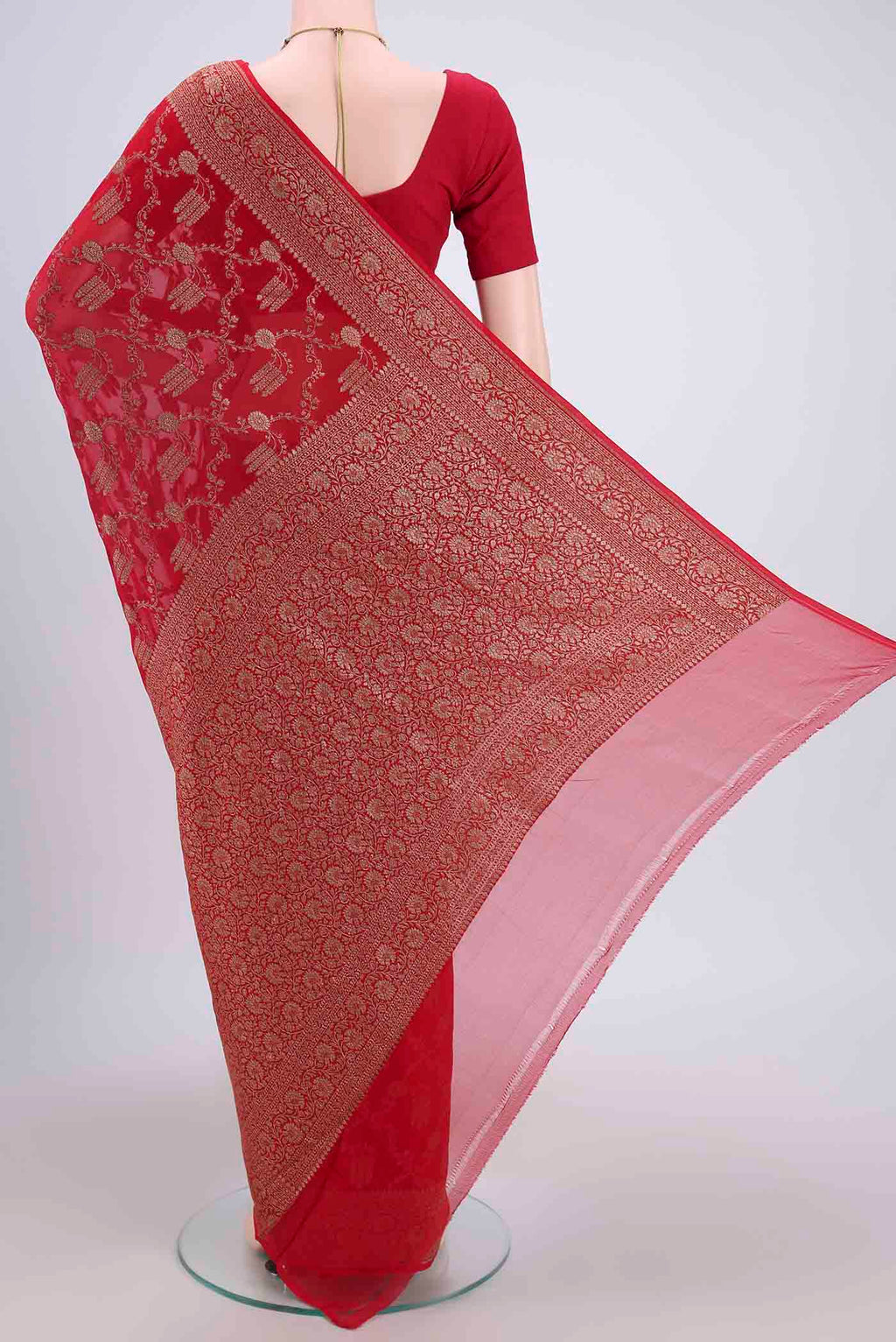 Flat view of Red Banarasi Georgette Saree with Zari Brocade on the body and Zari Border. 
