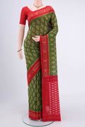 Light Green Pochampally Cotton Saree with Ikat design on the body and Ikat Border.  displayed on a mannequin