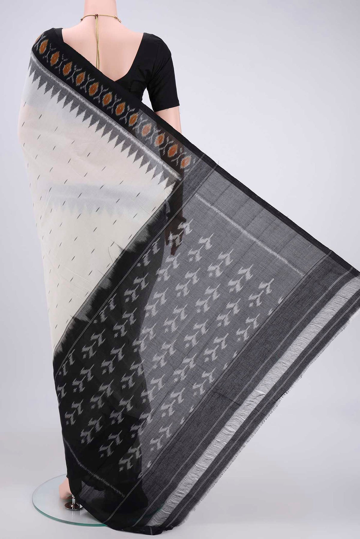 Flat view of Off White Dual Tone Pochampally Cotton Saree with Ikat design on the body and Ikat Border. 