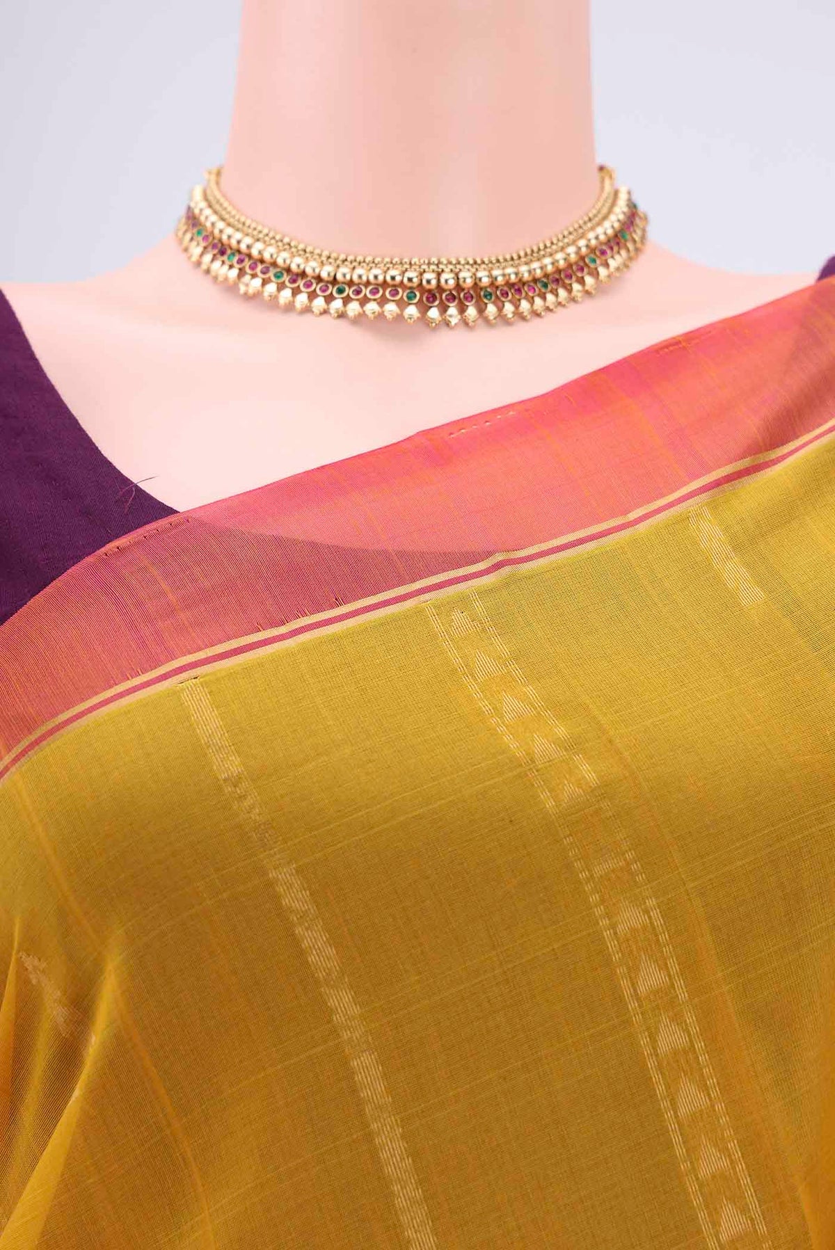Border image of Yellow Silk Cotton Saree with Zari Butta on the body and Zari Border. 