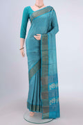 Turquoise Tussar Silk Saree with Printed design on the body and Zari Border.  displayed on a mannequin