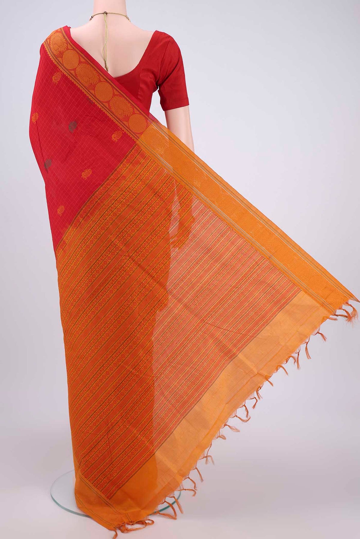 Flat view of Red Blended Poly Cotton Saree with Zari Butta on the body and Zari Border. 