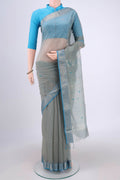 Beige Maheshwari Silk Cotton Saree with Zari And Thread Butta on the body and Zari Border.  displayed on a mannequin