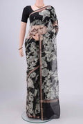 Black Kota Silk Saree with Printed design on the body and Zari Border.  displayed on a mannequin